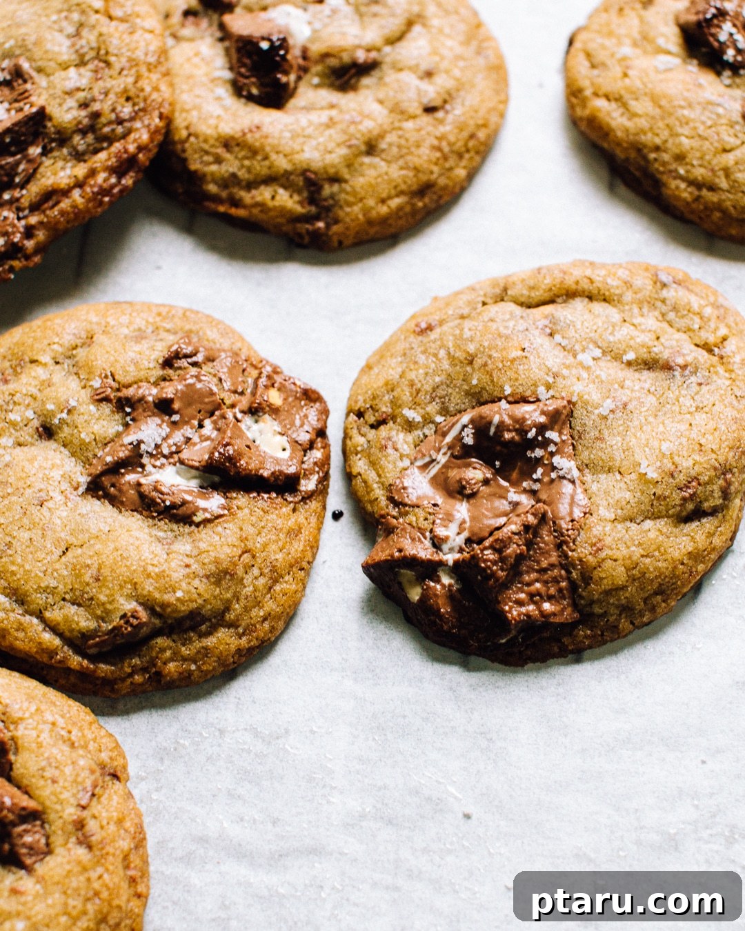 Irresistible Toblerone Cookies 5 Stacked Toblerone cookies with melted chocolate, on a cooling rack.