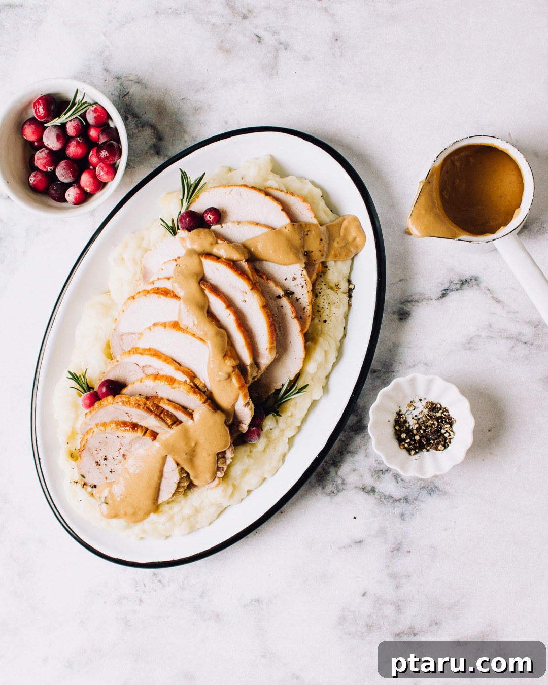 Savory Make-Ahead Herb and Pepper Gravy 2 Plate of turkey with homemade brown gravy drizzled overtop, showcasing the rich, smooth texture.