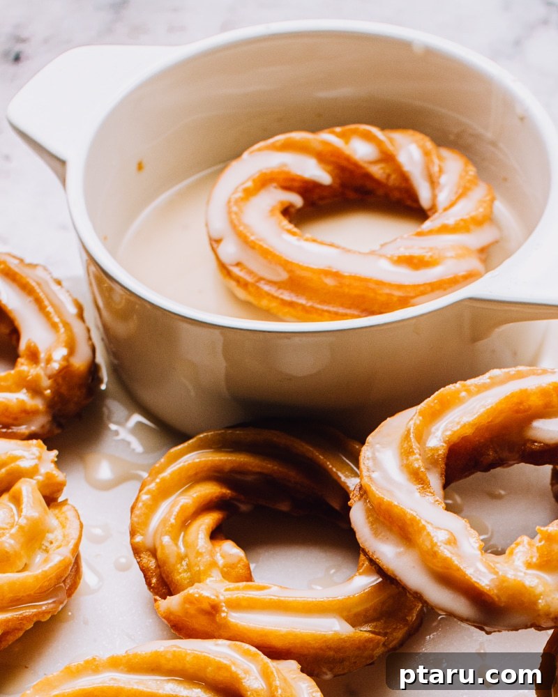Airy French Doughnuts 15 Golden-brown French Crullers cooling on a wire rack after frying