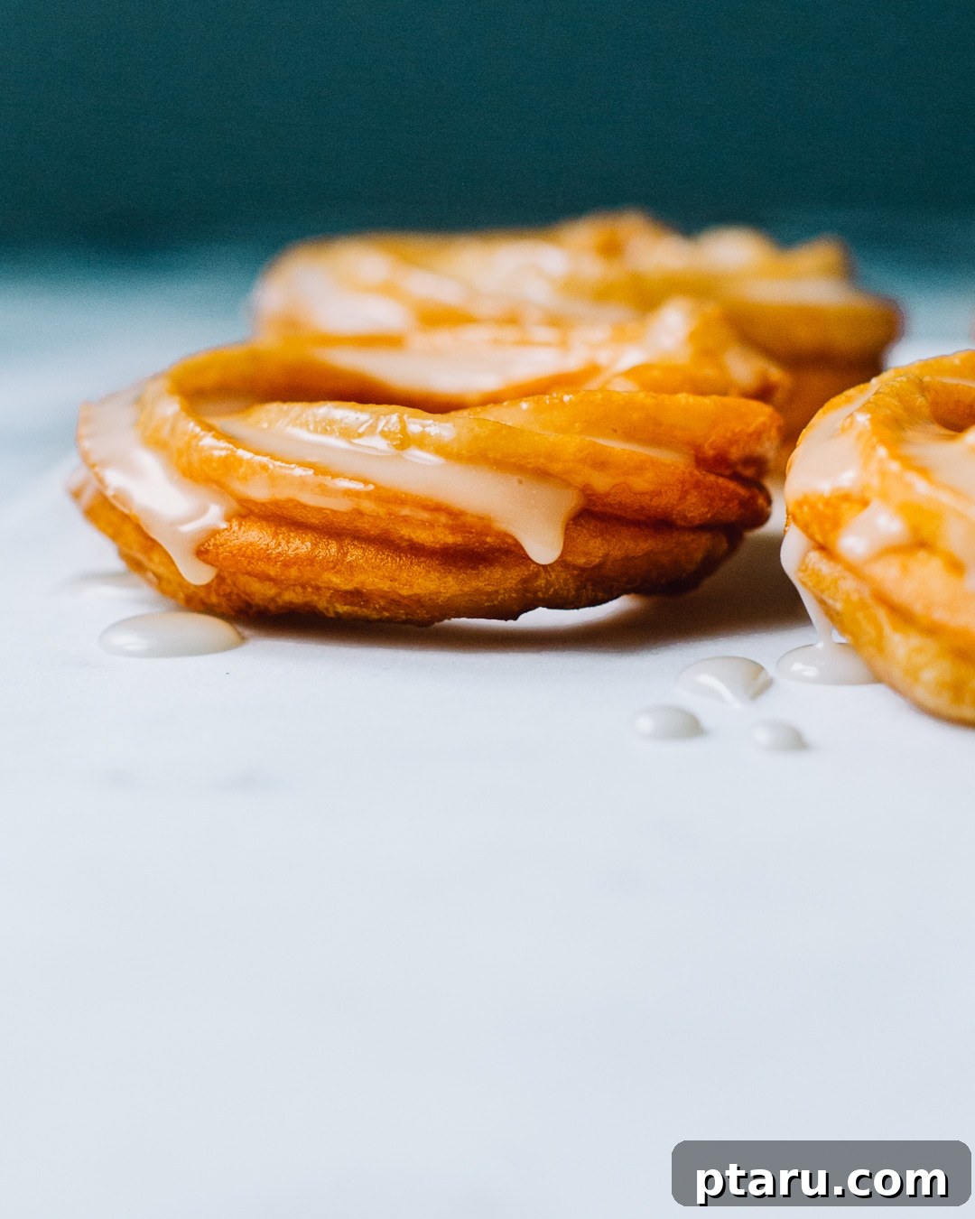 A stack of perfectly glazed homemade French Crullers ready to be enjoyed