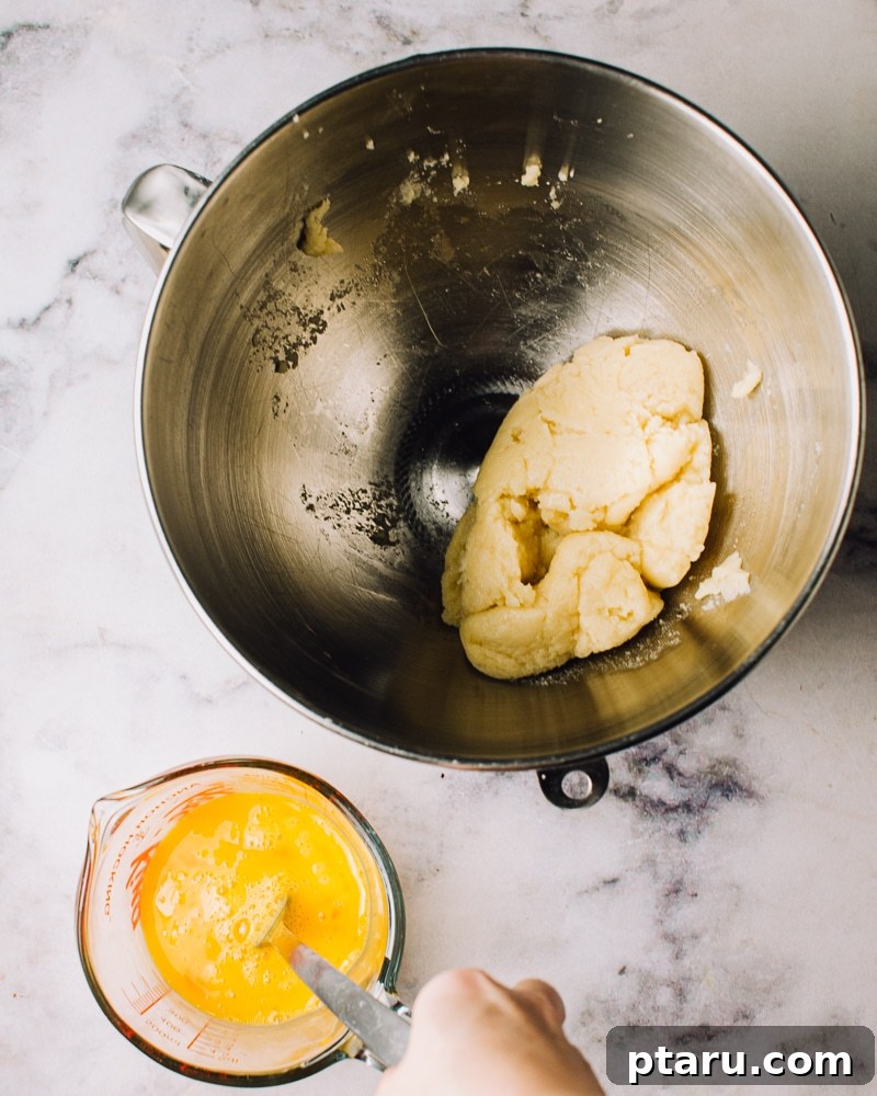 Airy French Doughnuts 9 Transferring choux pastry dough to a stand mixer to cool