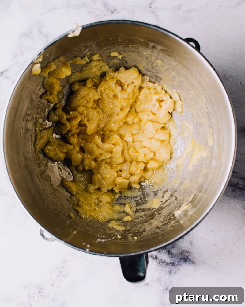 Airy French Doughnuts 10 Adding beaten eggs gradually to choux pastry dough in a stand mixer