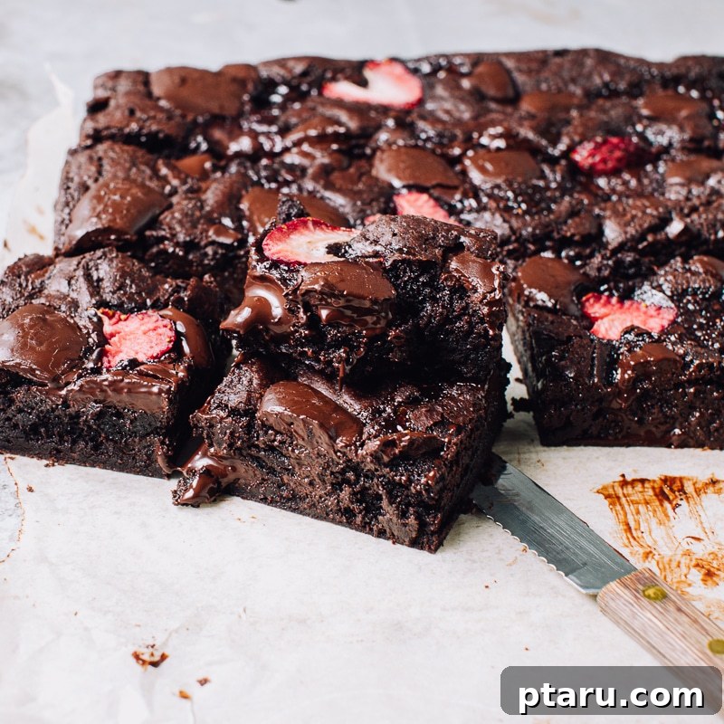 Ruby Red Brownie Bliss 5 A final shot of the gorgeous strawberry brownies, sliced and ready to be served, showcasing their fudgy texture and delicious toppings.