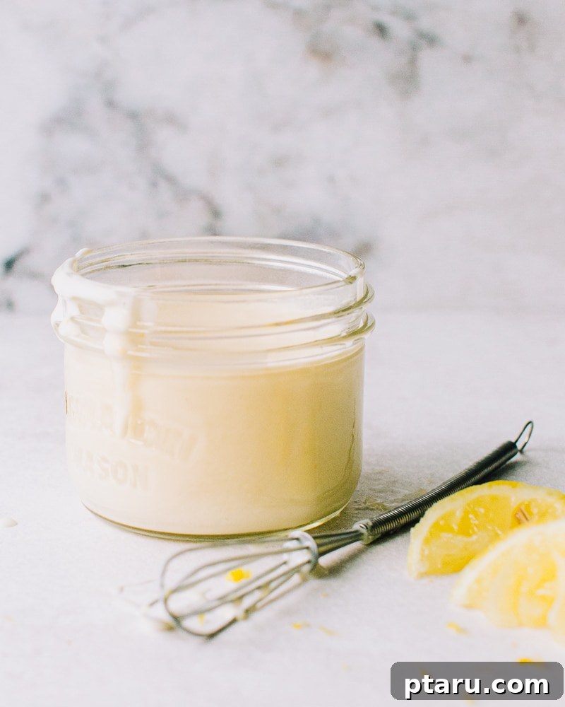 Tangy Lemon Yogurt Sauce 2 A jar of homemade Lemon Yogurt Sauce, showcasing its creamy texture and vibrant color.