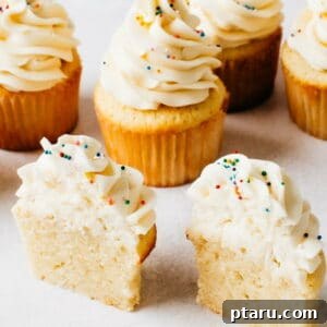 The best vanilla cupcake recipe, featuring a beautifully frosted cupcake.
