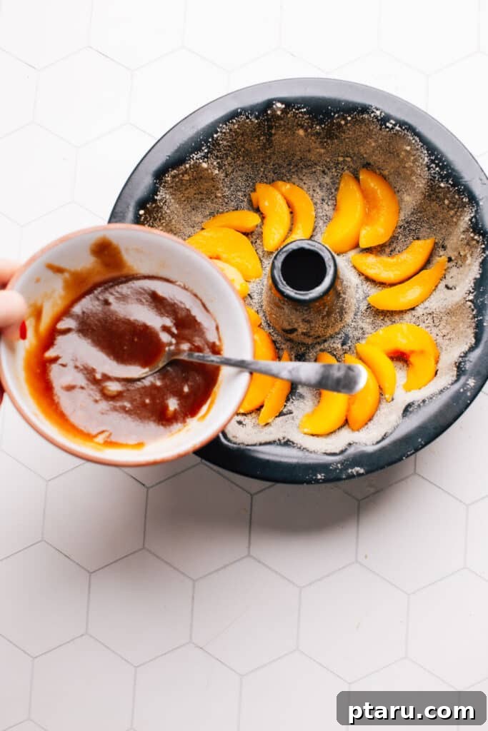 Grandma's Peach Cobbler Pound Cake 5 Pouring the peach cobbler topping into a greased Bundt pan