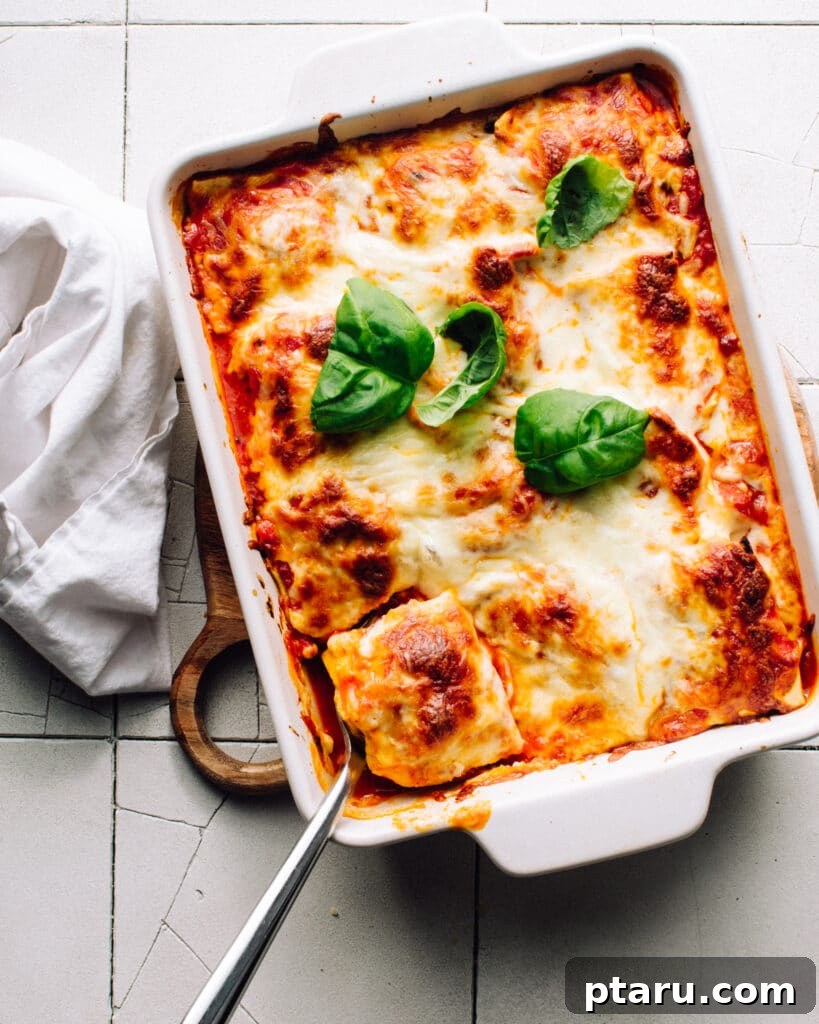 The Easiest 3-Ingredient Lasagna 4 Scooping out a portion of lazy lasagna made with ravioli.