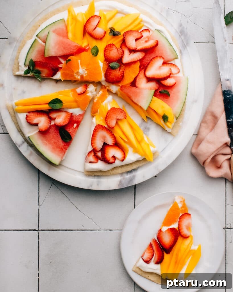 Ultimate Fruit Pizza: Cookie Crust Bliss, Cream Cheese Cloud 2 A beautifully decorated fruit pizza with a sugar cookie crust and fluffy cream cheese frosting, adorned with colorful fresh fruits. Perfect for Easter, Memorial Day, or Canada Day.