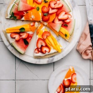 This Fruit Pizza recipe has the best, fluffy cream cheese frosting and an easy sugar cookie base. You can make fun, beautiful fruit designs into Easter eggs, a patriotic flag for Memorial Day or Canada Day, or any holiday.