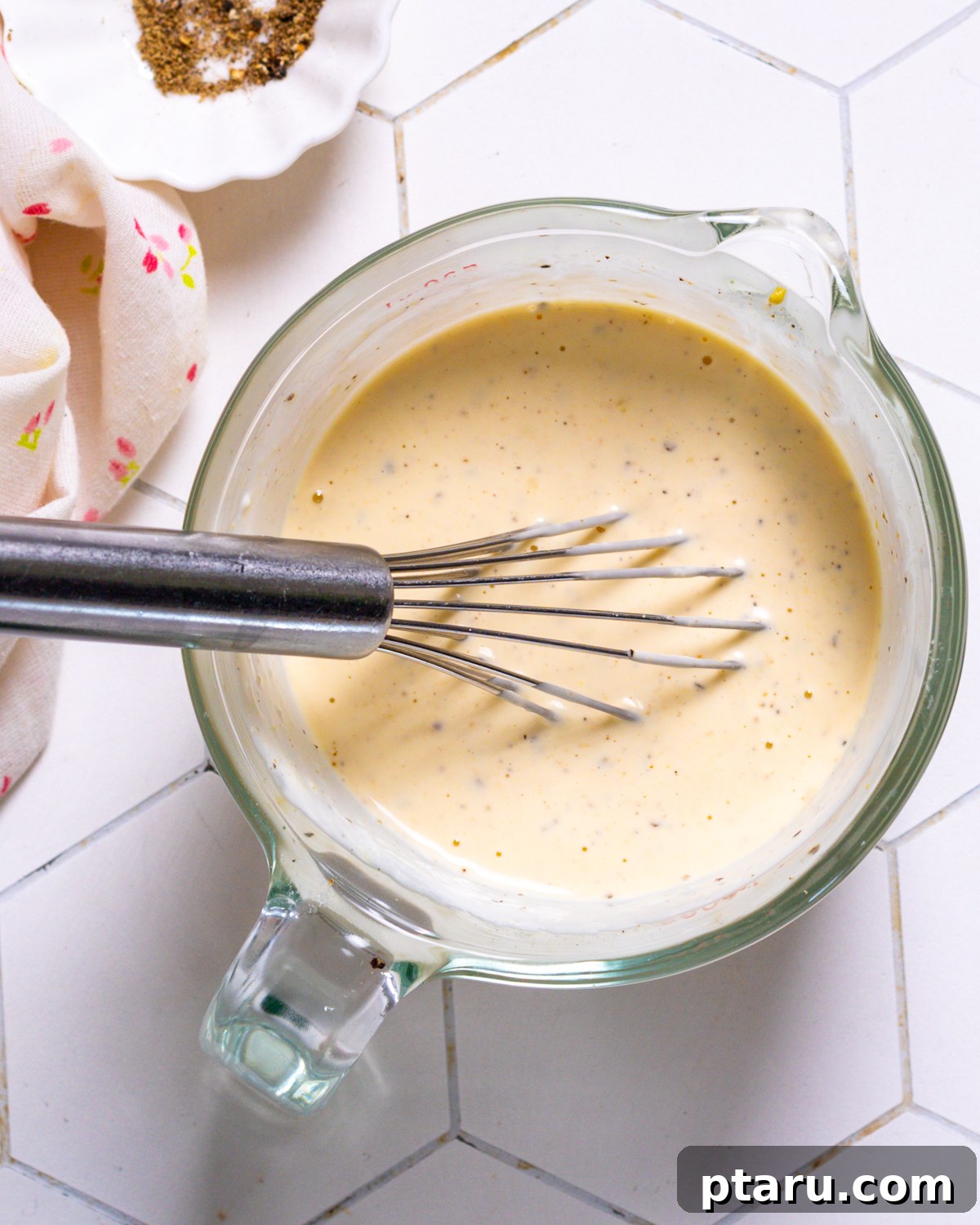 Velvety Potato and Egg Salad 7 Alabama white sauce with a whisk.