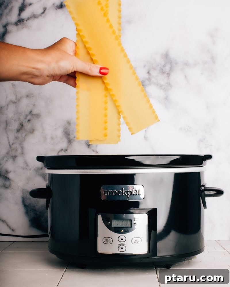 Effortless Cheesy Slow Cooker Lasagna 5 Layered crockpot lasagna ready for cooking