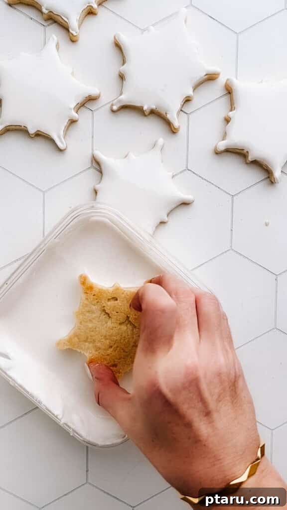 Glistening Snowflakes 9 Dunking a snowflake cookie facedown into a bowl of royal icing.