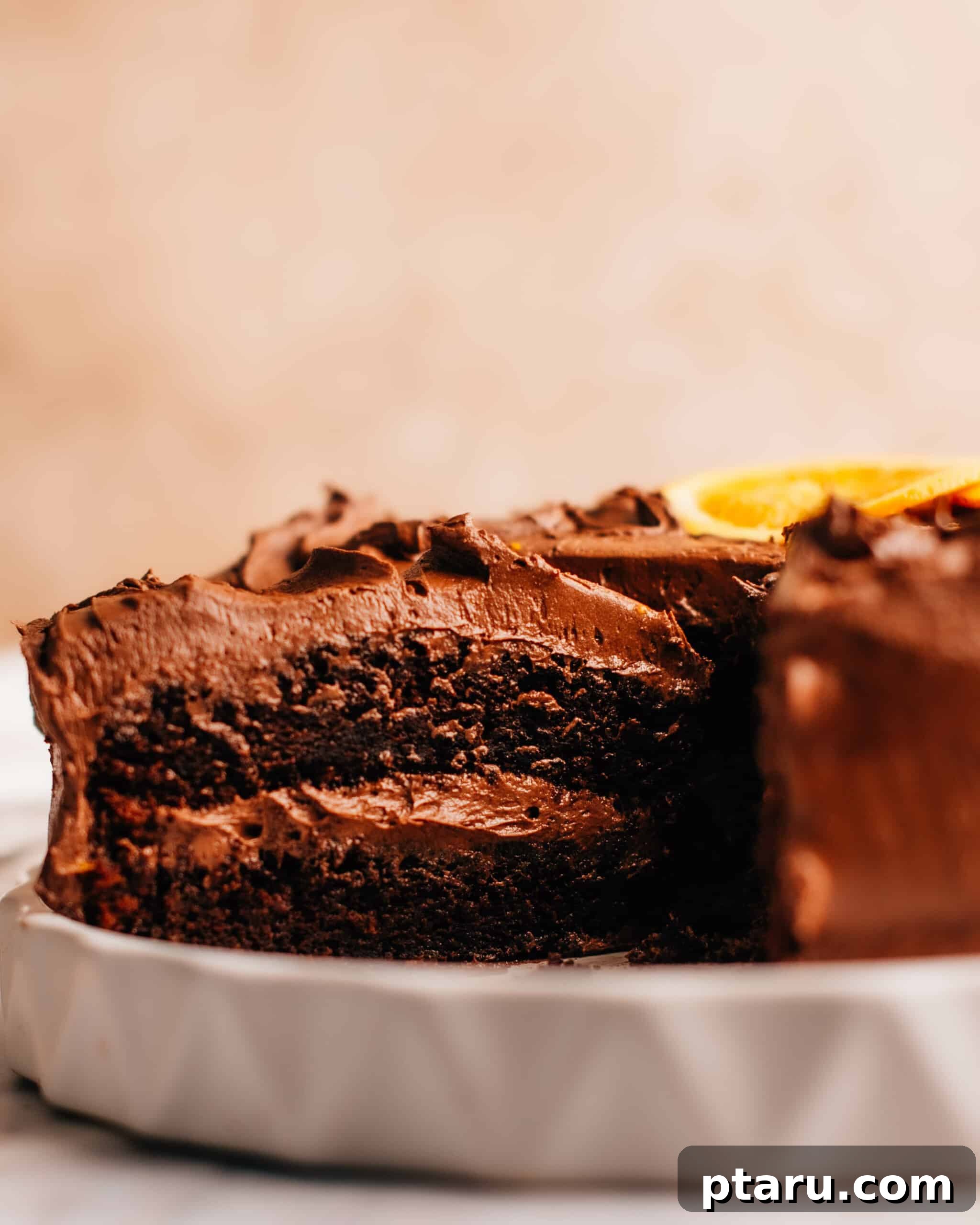 20 Deliciously Easy Chocolate Christmas Desserts 11 A hand cutting a slice of Moist Orange Cake, revealing its tender, flavorful interior.