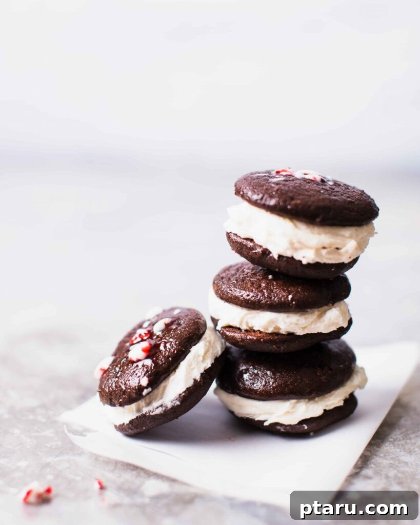 20 Deliciously Easy Chocolate Christmas Desserts 14 A delightful stack of Peppermint Whoopie Pies, showcasing their soft, cakey cookies and creamy marshmallow frosting.