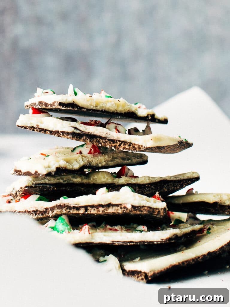 20 Deliciously Easy Chocolate Christmas Desserts 19 A stack of artfully broken pieces of peppermint candy cane bark, showcasing its festive colors and appealing textures.