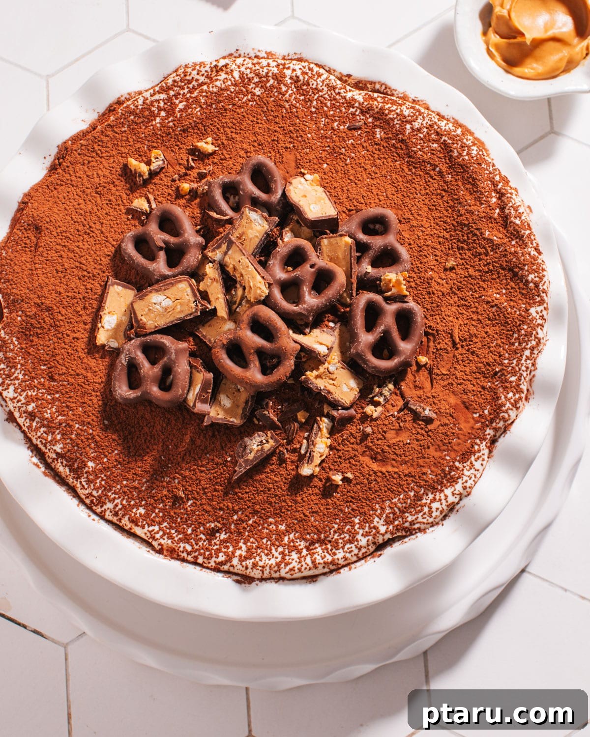 20 Deliciously Easy Chocolate Christmas Desserts 9 A delectable Peanut Butter Pretzel Pie presented in a dish, showcasing its inviting layers and textures.