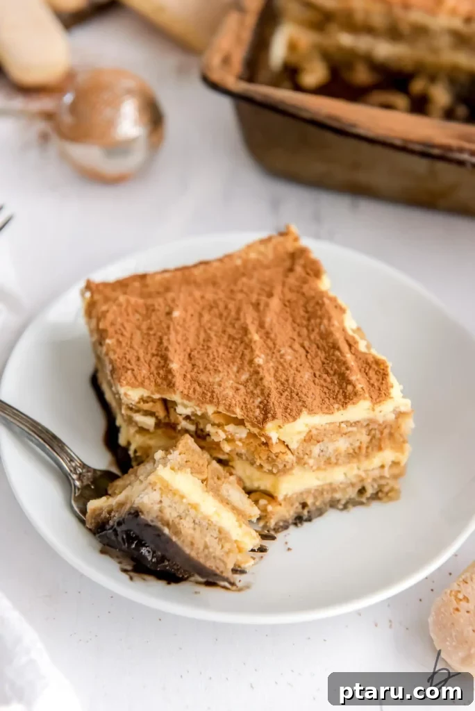 15 Irresistible Italian Desserts to Sweeten Your Christmas 15 A perfectly portioned piece of authentic Italian Tiramisu, served on a plate with a fork, revealing its luscious layers of coffee-soaked ladyfingers and creamy mascarpone.