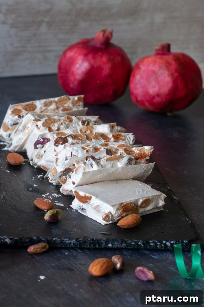 15 Irresistible Italian Desserts to Sweeten Your Christmas 7 Delicate pieces of classic Italian nougat (Torrone), studded with nuts, beautifully arranged to showcase their light and chewy texture, a traditional highlight of Christmas dessert tables.