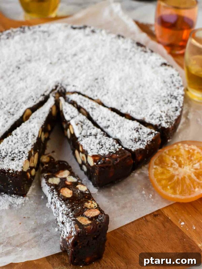 15 Irresistible Italian Desserts to Sweeten Your Christmas 8 Exquisite slices of traditional Panforte, richly textured with nuts and dried figs, arranged on parchment paper, symbolizing the timeless elegance of Italian Christmas confectionery.