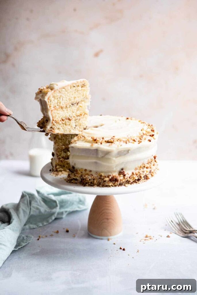 15 Irresistible Italian Desserts to Sweeten Your Christmas 10 A hand elegantly slicing into a luscious 3-layer Italian cream cake, revealing its moist interior filled with coconut and pecans, all enveloped in a smooth cream cheese glaze.