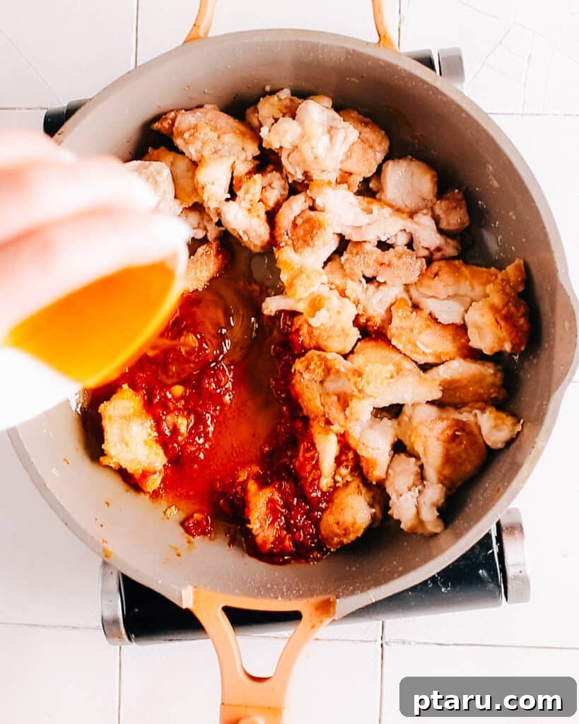 Korean Sticky Gochujang Chicken 6 Adding honey to gochujang chicken sauce.