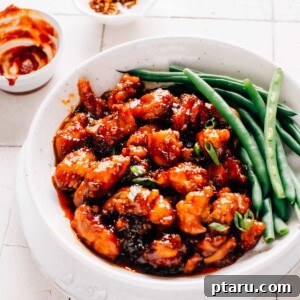 Gochujang chicken and green beans in a shallow bowl ready to enjoy.