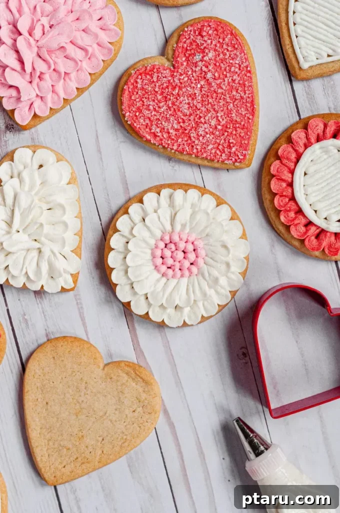 Love at First Bite: Simple Valentine's Sugar Cookies 13 Delicately decorated honey sugar cookies alongside a cookie cutter and piping bag, ready for creative Valentine's Day designs.