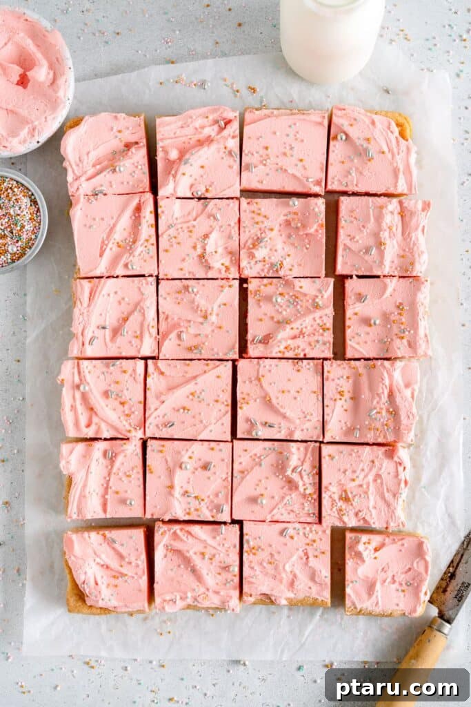 Love at First Bite: Simple Valentine's Sugar Cookies 14 Perfectly sliced squares of vanilla sugar cookie bars topped with creamy frosting and festive sprinkles, ready to serve.