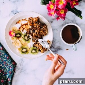 Mega Clump Granola served in a bowl with fresh fruit and yogurt.