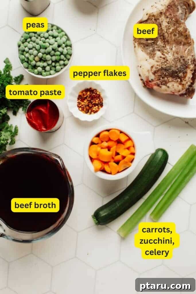 Homestyle Fork-Tender Beef and Vegetable Soup 3 Fresh ingredients for Beef Vegetable Soup, including various vegetables, beef, and spices, laid out on a kitchen counter.