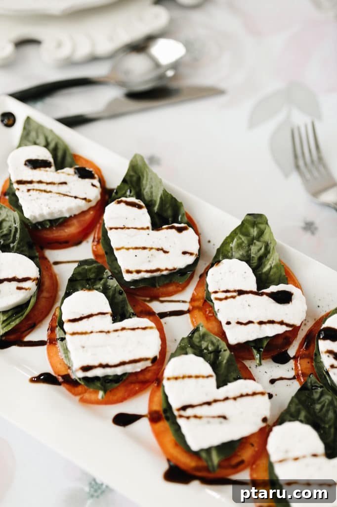 14+ Stress-Free & Delicious Valentine's Family Dinners 11 A plate of Heart-shaped Caprese Salad, made with fresh tomatoes, mozzarella, and basil.
