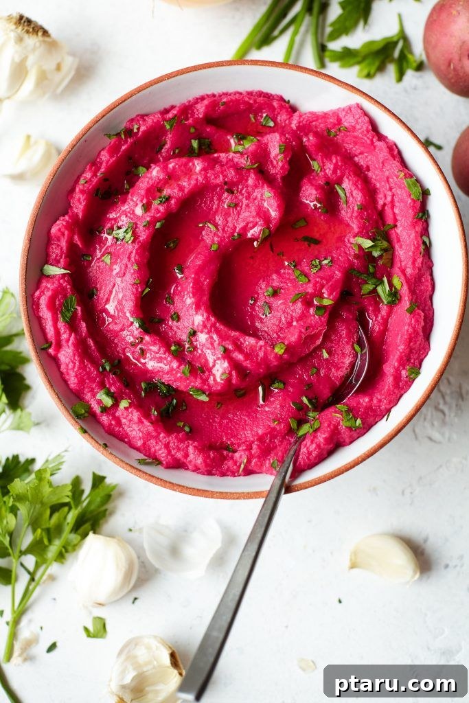 14+ Stress-Free & Delicious Valentine's Family Dinners 12 A ceramic bowl of Beet Mashed Potatoes for family valentine's day dinner topped with fresh cilantro