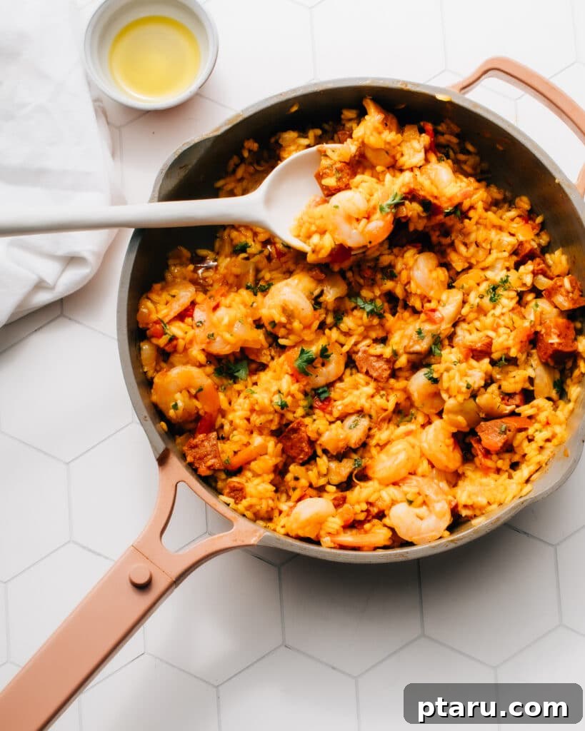 14+ Stress-Free & Delicious Valentine's Family Dinners 17 Chorizo paella in a pan with a serving spoon
