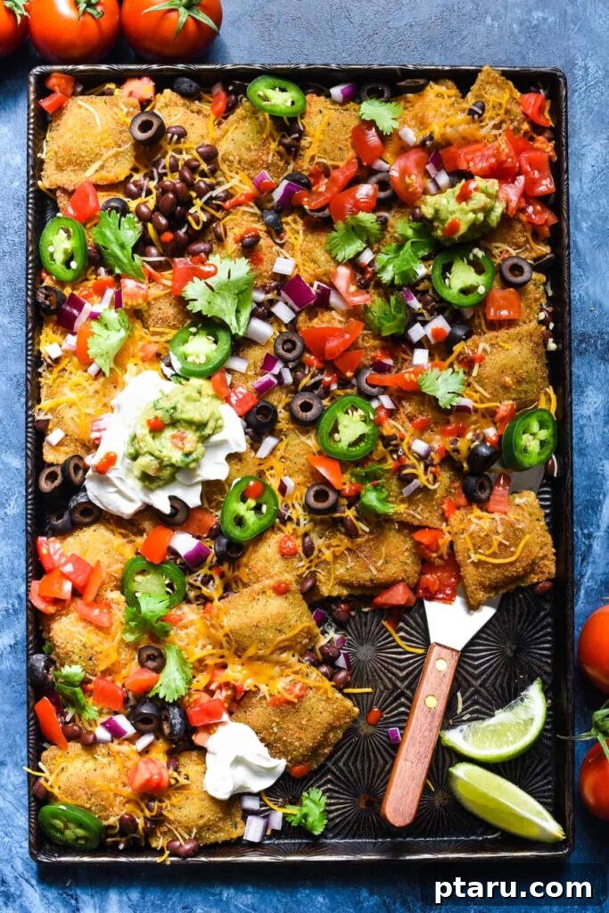 Epic Game Day Nachos: 15 Simple Recipes for Your Crowd 15 Crispy toasted ravioli nachos baked on a sheet pan, showcasing the golden ravioli and melted cheese with various toppings.