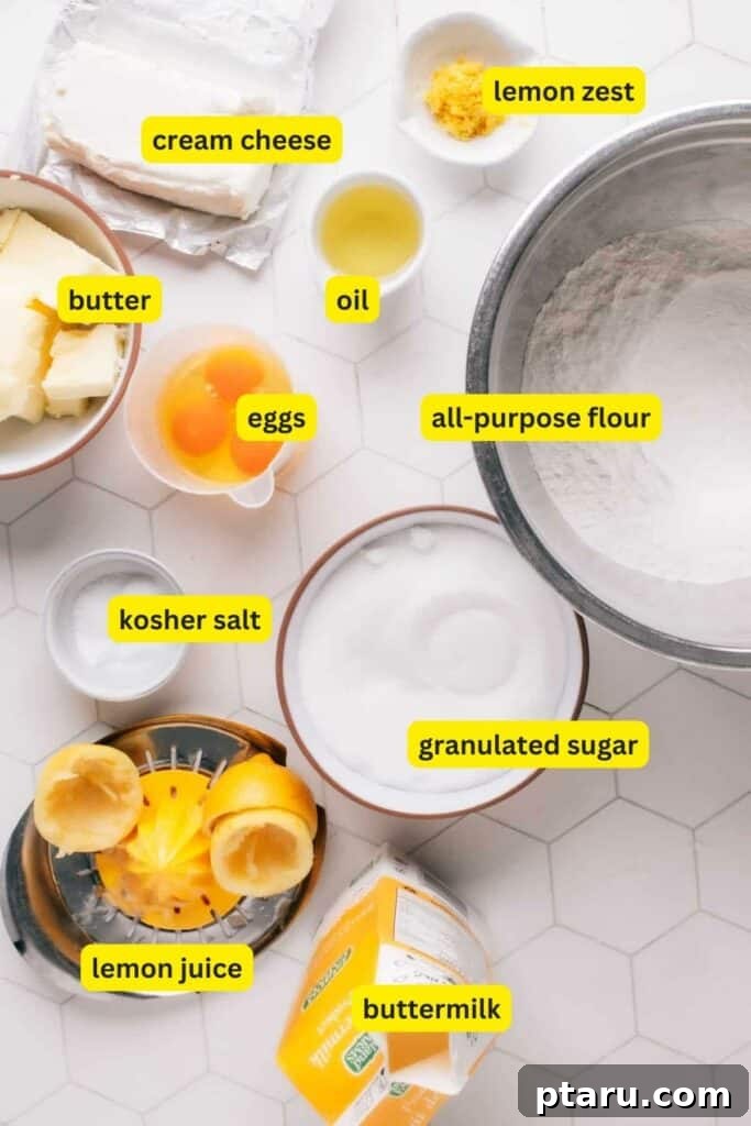 Zesty Lemon Dream Cake 5 A curated selection of ingredients for Lemon Curd Cake, neatly arranged on a clean kitchen countertop. Includes all-purpose flour, fresh eggs, soft cream cheese, bright lemons, creamy butter, neutral oil, granulated sugar, rich buttermilk, and more, ready for baking.