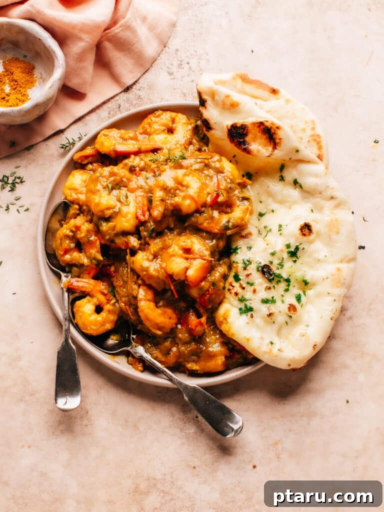 Island Soul Shrimp Curry 6 A beautifully plated serving of Jamaican Curry Shrimp, garnished with fresh cilantro, alongside warm flatbread, ready to be enjoyed.