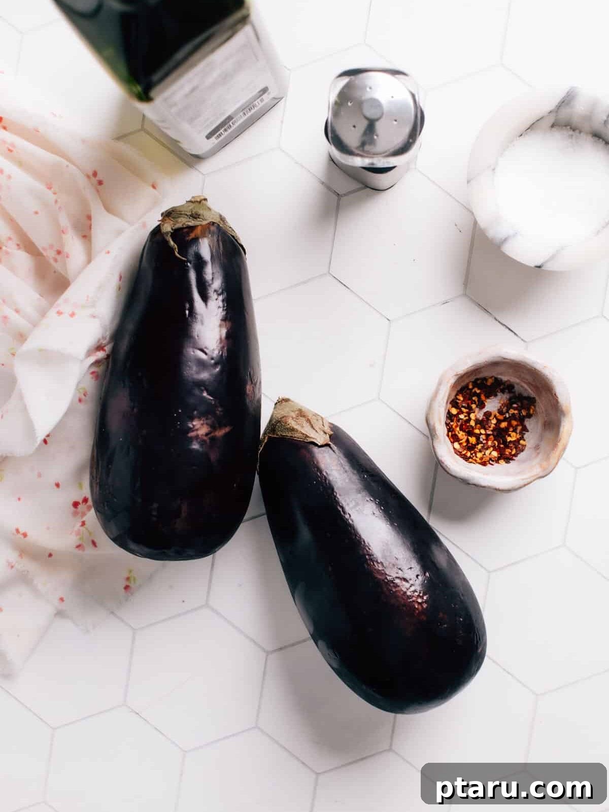 Perfectly Crispy Air-Fried Eggplant 3 A selection of fresh ingredients including eggplant, avocado oil, and salt, laid out on a counter, ready for air frying.