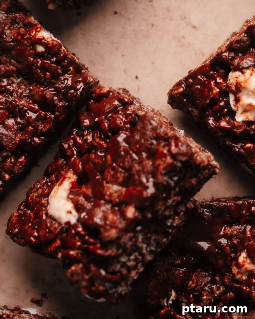 Decadent Chocolate Crunch Bars 2 Chocolate Rice Krispie Treats cut in squares, showing their soft, chewy texture and rich chocolate color