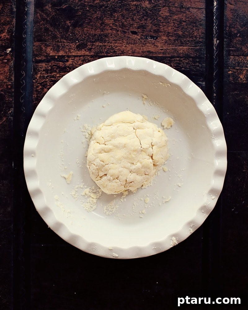 Skip the Rolling Pin: Easiest Press-In Butter Pie Crust 3 Ingredients for no-roll pie crust laid out on a counter, including flour, salt, butter, and ice water.