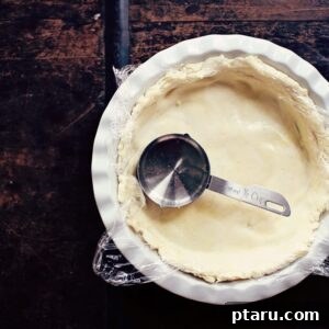 A slice of delicious pumpkin pie with the easy no-roll crust, topped with whipped cream.