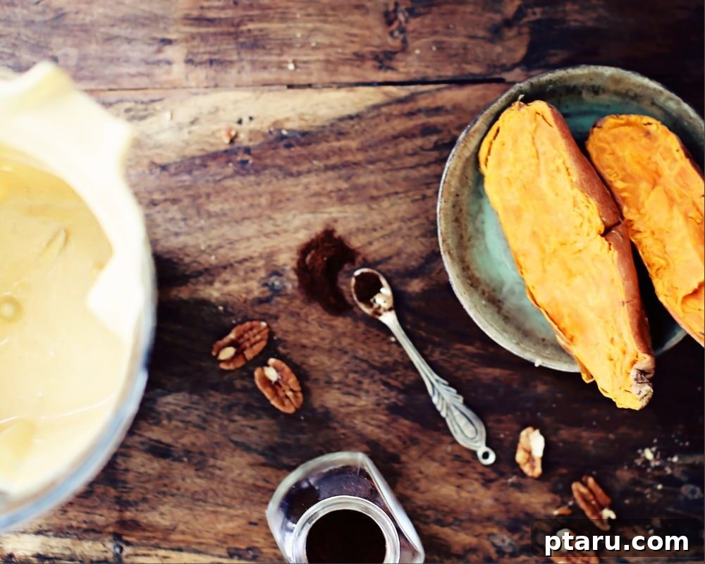 Velvety Sweet Potato Cheesecake with Toasted Pecan Crust 3 All the ingredients for the sweet potato cheesecake laid out on a kitchen counter, including pecans, oats, sweet potatoes, cream cheese, and spices.