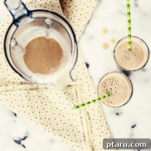 Sweet Potato Smoothie in a tall glass, garnished with a sprinkle of cinnamon.