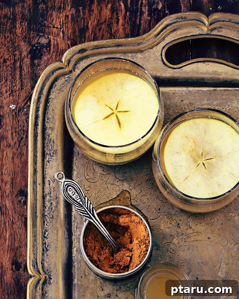 Yuletide Apple Glow 4 Key ingredients for the Spiced Apple Bourbon Cocktail: apple cider, maple syrup, bourbon, and cinnamon.