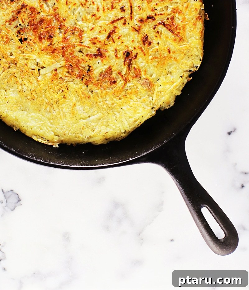 Golden Rosti Quiche: Sausage, Caramelized Onion, and Gruyere 4 Grimm's Turkey Farmer Sausage rounds being sliced and browned in a hot skillet for the quiche filling.