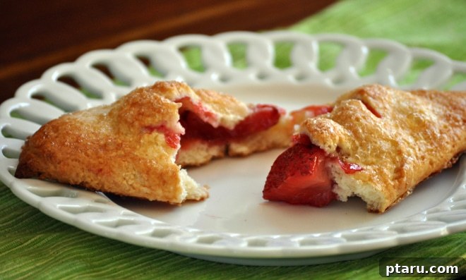 Strawberry Cream Cheese Pastry Pockets 3 Close-up of baked strawberry hand pies, showcasing the golden pastry and sweet filling.