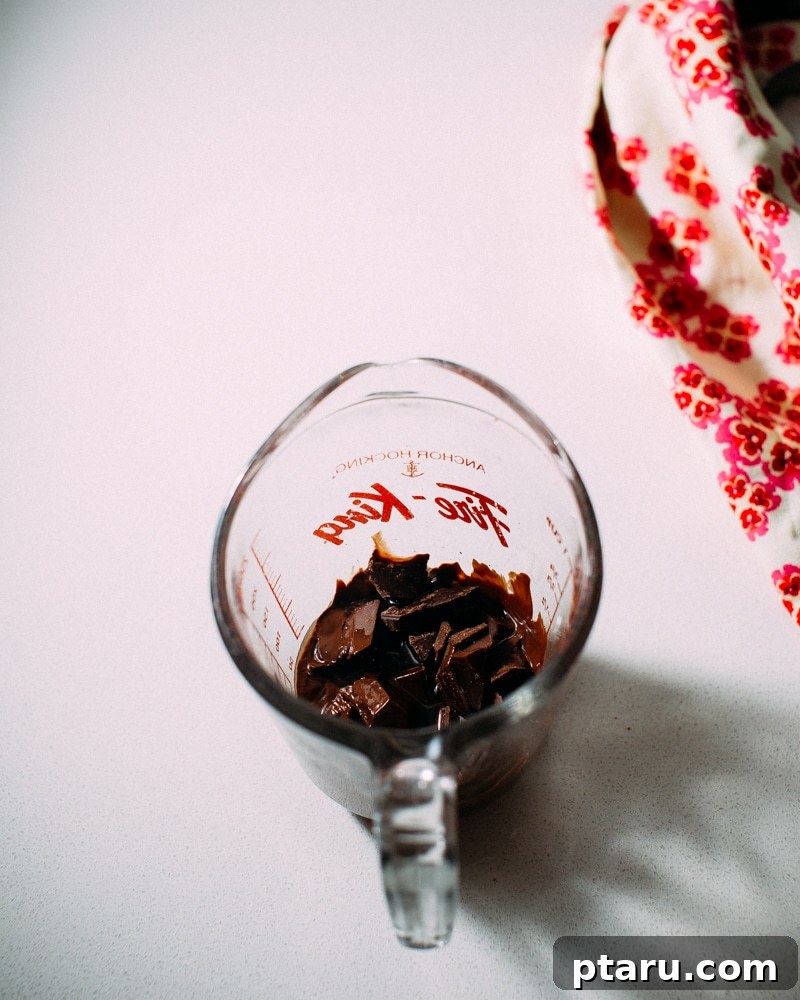 Effortless Instant Chocolate Coating 3 Melted chocolate and coconut oil in a bowl, ready to be stirred.