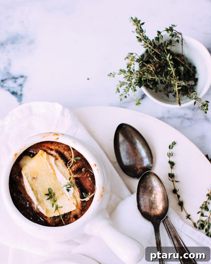Golden Brie Crowned French Onion Soup 4 Close-up of golden-brown caramelized onions in a Dutch oven, showing the rich color and texture.