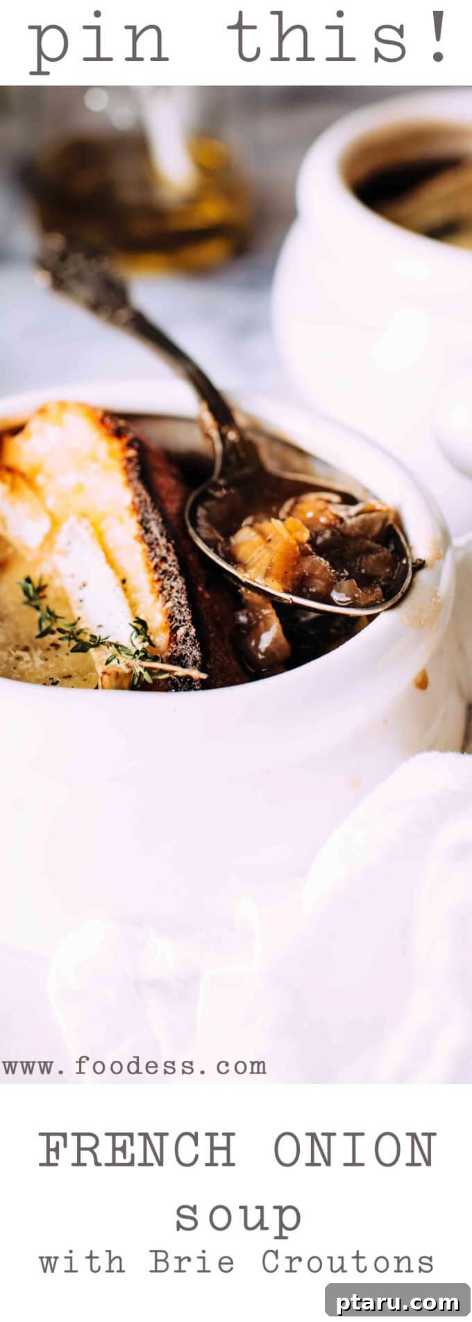 Golden Brie Crowned French Onion Soup 5 Four individual bowls of French Onion Soup, each topped with a perfectly broiled brie crouton, ready to be served.