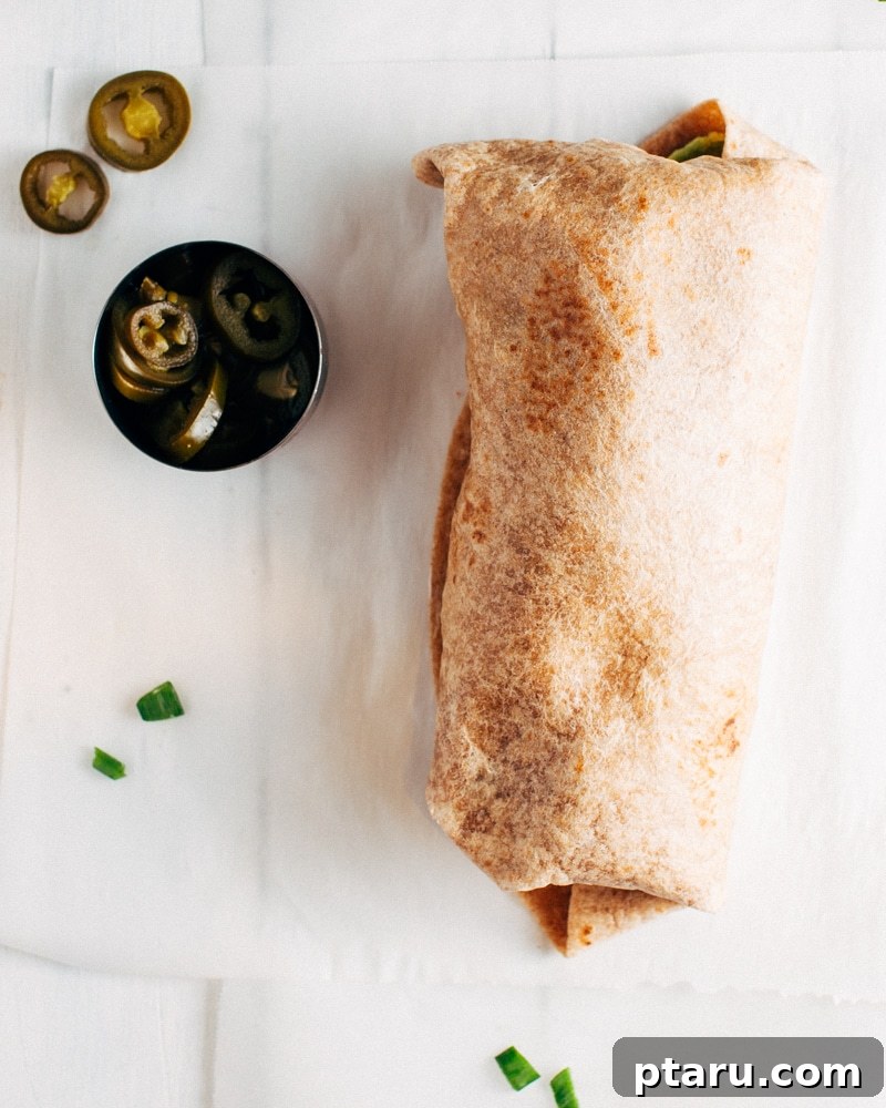 Vibrant Mexican Rice Bean and Greens Burritos 5 A stack of perfectly rolled burritos, showcasing their neat, portable form, ideal for meal prep.