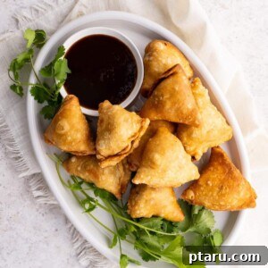 Savory Spiced Potato Samosas 9 A plate full of crispy potato samosas served with a side of chutney